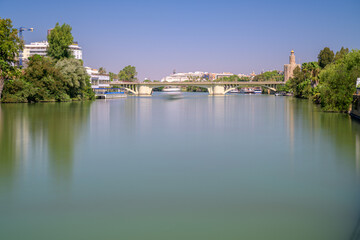 Fototapeta premium Views of San Telmo Bridge and Torre del Oro in Seville, Spain