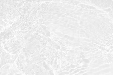 White water with ripples on the surface. Defocus blurred transparent white colored clear calm water surface texture with splashes and bubbles. Water waves with shining pattern texture background.