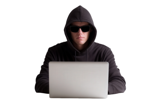 Individual in a dark hoodie and sunglasses seated at a laptop with a transparent background, engaged in focused activity, possibly working or browsing the internet