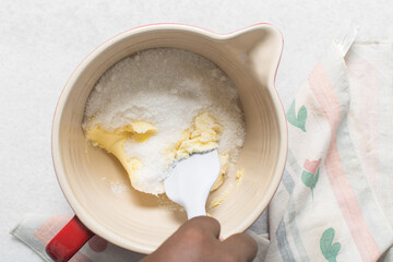 Top view of Creaming butter and sugar with a spatula, the process of making a cake or cookie