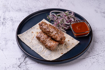 Delight in a gourmet experience with juicy, grilled skewers resting on soft flatbread, accompanied...