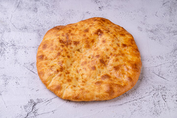 Golden, crusty bread rests on a textured surface, inviting the senses to explore its warmth and aroma. This culinary delight represents a tradition of artisanal baking, rich in history