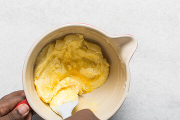 Creaming butter sugar and egg with a spatula, the process of making a cake and cookies, mixing butter and sugar to make a cake and cookies