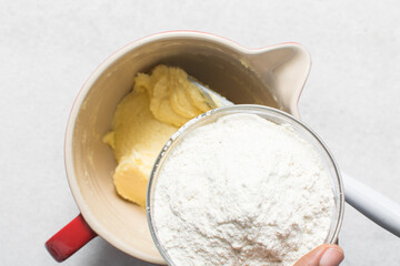 overhead view of All purpose flour in a bowl, top view of baking flour in a glass bowl