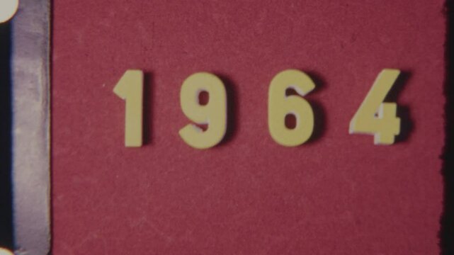 Old 8mm Film Strip Displaying 1964 Year On Textured Red Background