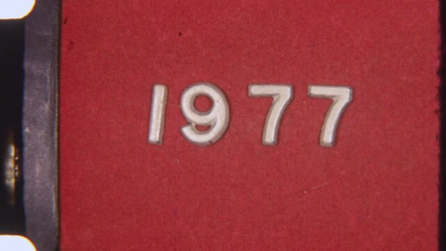 1977 Text On Red Background With Authentic 8mm Film Texture