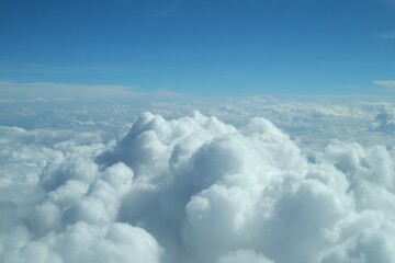 Aerial View of Fluffy White Clouds Against a Vivid Blue Sky