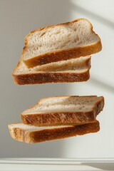 Floating Slices of Artisan Bread Against White Background