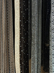 A selection of fashion leather belts hanging in a rack