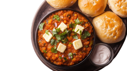 Delicious bowl of spicy vegetable curry with rolls, garnished with butter and fresh herbs.