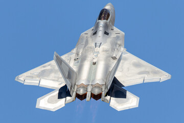 Top view of a a F-22 Raptor  in beautiful light with afterburners on