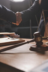 Attractive young lawyer in office Business woman and lawyers discussing contract papers with brass scale on wooden desk in office. Law, legal services, advice, Justice and real estate concept.