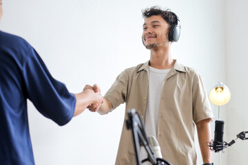 Speaker and Guest Shaking Hands Before Starting Live Streaming Podcast in Studio