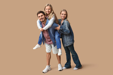 Fototapeta premium Happy family in stylish denim clothes on brown background