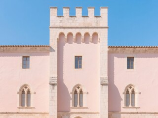 Historic Building with Crenellated Tower and Arched Windows