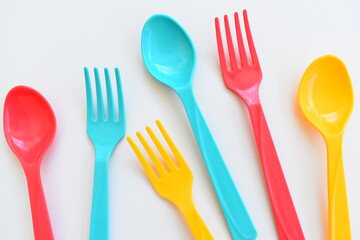 colorful spoon and fork isolated on white background, plastic cutlery for picnic