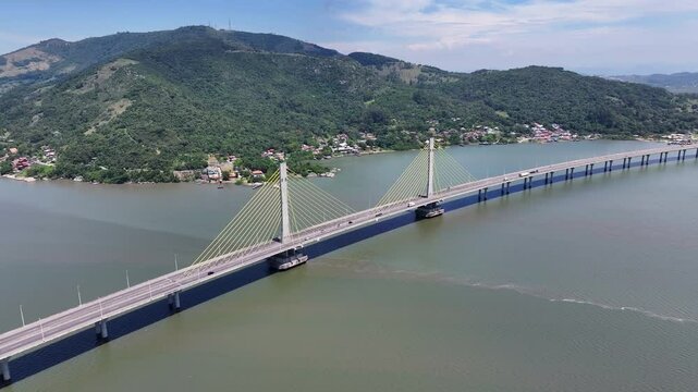 Anita Garibaldi Bridge In Laguna Santa Catarina Brazil. Breathtaking Aerial View Of Busy Traffic In A Freeway Road. Coast Clouds Sky Seaside Summertime. Coast Panning Wide. Laguna Santa Catarina.
