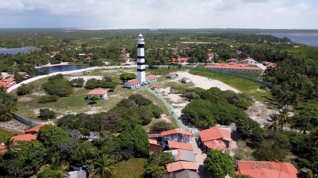 Mandacaru Lighthouse In Barreirinhas Maranhao Brazil. Lighthouse Standing Tall On Beach With Ocean Waves Crashing. Coast Clouds Sky Seaside Summertime. Outdoor Seaside Tropical Environment.