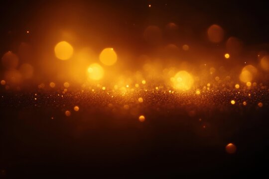 Golden glowing bokeh lights scattered above dark surface with warm amber tone creating magical luminous effect