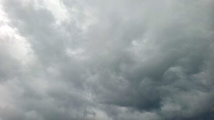 Fototapeta premium The ominous sky is filled with dense, swirling storm clouds, indicating an approaching thunderstorm.