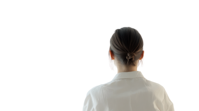 Woman with a bun looking into the distance, ideal for concepts of contemplation and introspection.