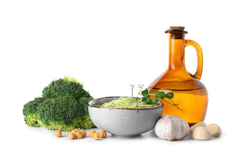 Bowl of tasty peas hummus with broccoli, microgreen and garlic on white background