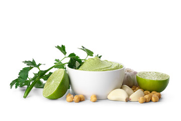 Bowl of tasty peas hummus with lime, parsley, chickpeas and garlic on white background