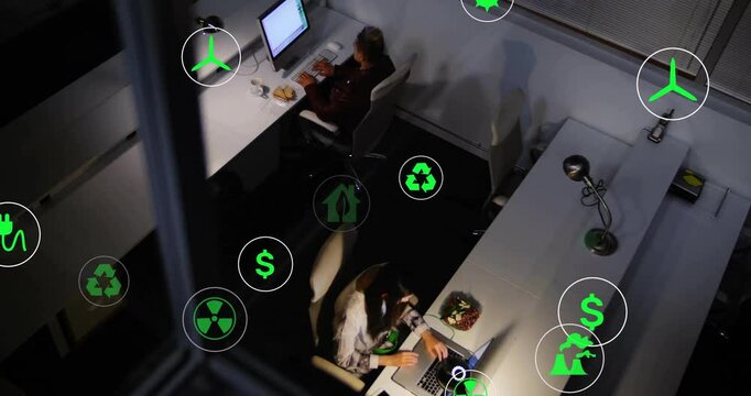 Co-workers typing while eco icons fading in, clustering, activating on hover for metrics evaluation