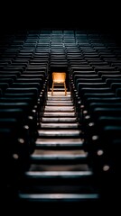Obraz premium A Single Illuminated Chair in a Dark Auditorium A Concept of Solitude and Individuality.