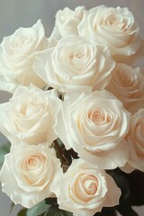 Obraz premium Close-up of a bouquet of soft creamy white roses with delicate layered petals, evoking purity and elegance