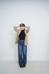 A collection of studio portraits featuring a stylish young woman posing in various confident stances against a clean white background.