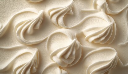 Close-up of creamy, off-white frosting with delicate swirls and piped rosettes, creating an elegant texture