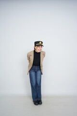 A collection of studio portraits featuring a stylish young woman posing in various confident stances against a clean white background.