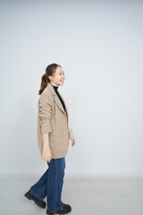 A collection of studio portraits featuring a stylish young woman posing in various confident stances against a clean white background.