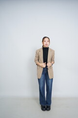 A collection of studio portraits featuring a stylish young woman posing in various confident stances against a clean white background.