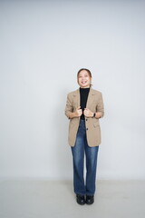 A collection of studio portraits featuring a stylish young woman posing in various confident stances against a clean white background.