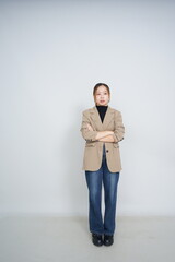 A collection of studio portraits featuring a stylish young woman posing in various confident stances against a clean white background.