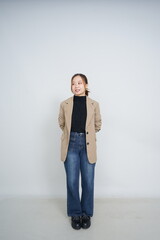A collection of studio portraits featuring a stylish young woman posing in various confident stances against a clean white background.