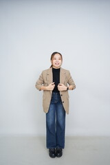 A collection of studio portraits featuring a stylish young woman posing in various confident stances against a clean white background.