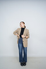 A collection of studio portraits featuring a stylish young woman posing in various confident stances against a clean white background.