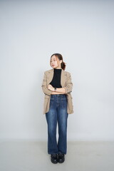 A collection of studio portraits featuring a stylish young woman posing in various confident stances against a clean white background.