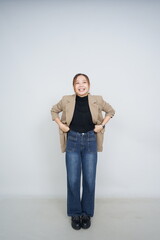 A collection of studio portraits featuring a stylish young woman posing in various confident stances against a clean white background.
