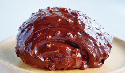 Close up Chocolate coated croissant with fudge chunks, Fresh baked made of croissant dough, sweet bakery pastry, specialty menu