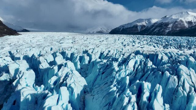 Perito Moreno Glacier In El Calafate Patagonia Argentina. Glacier Calving Into Icy Lagoon With Snow Capped Mountains. Snowing Lake Glacial Lake Snow Capped. Snowing Nature. El Calafate Patagonia.