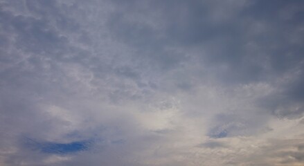 a clear afternoon sky with blue and white clouds