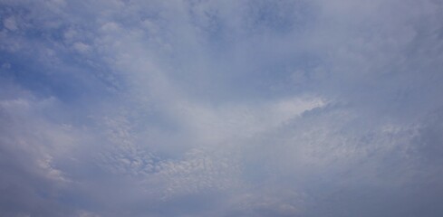 a clear afternoon sky with blue and white clouds