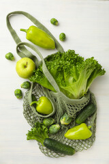 Set of protein vegetables and bag on white wooden background, top view