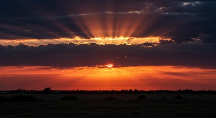 Photo of Dramatic Sunset Over a Field With Sunrays