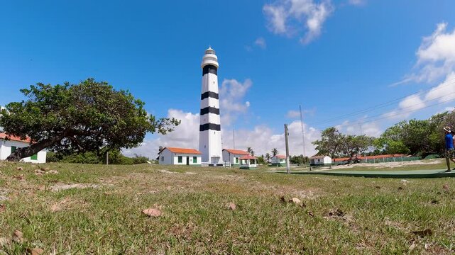 Mandacaru Lighthouse In Barreirinhas Maranhao Brazil. Lighthouse Standing Tall On Beach With Ocean Waves Crashing. Landscape Sky Clouds Waterfall Tropical. Outside Waterfall Powerful Flow.