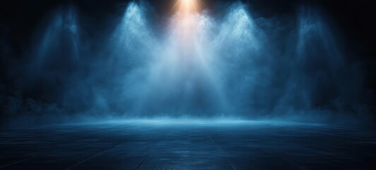 Dimly lit empty stage with blue spotlights and mist creating a mysterious and atmospheric scene